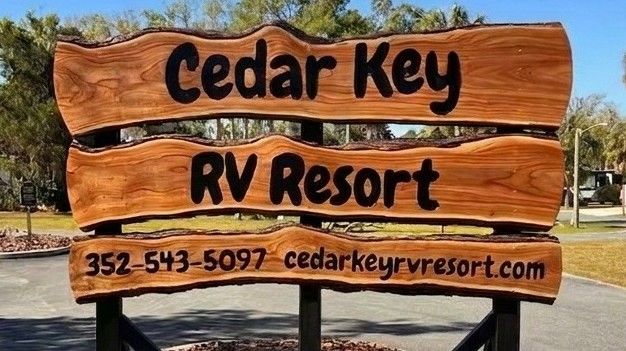 Entrance sign at Cedar Key RV Resort with RV arrival